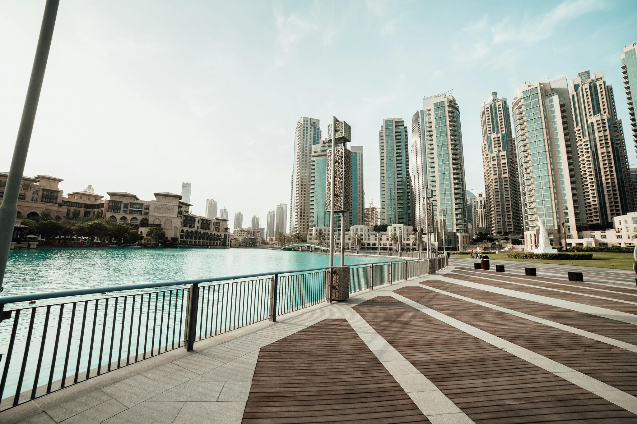 The view of the Burj Park in Dubai with the waterfront, buildings, and skyscrapers.
