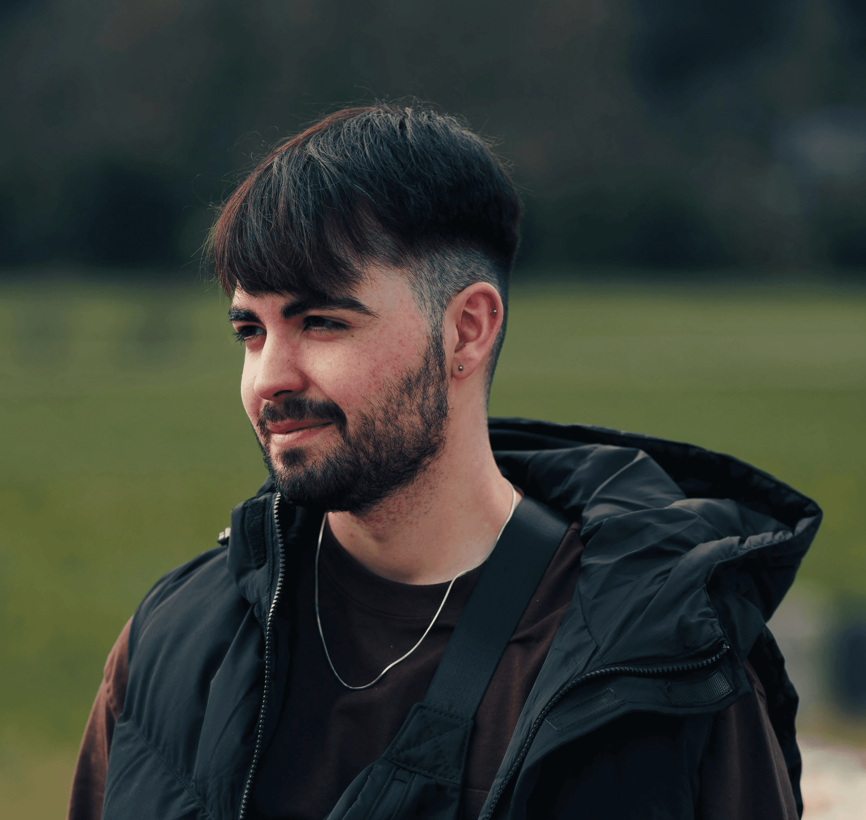 a man with a beard wearing a black jacket