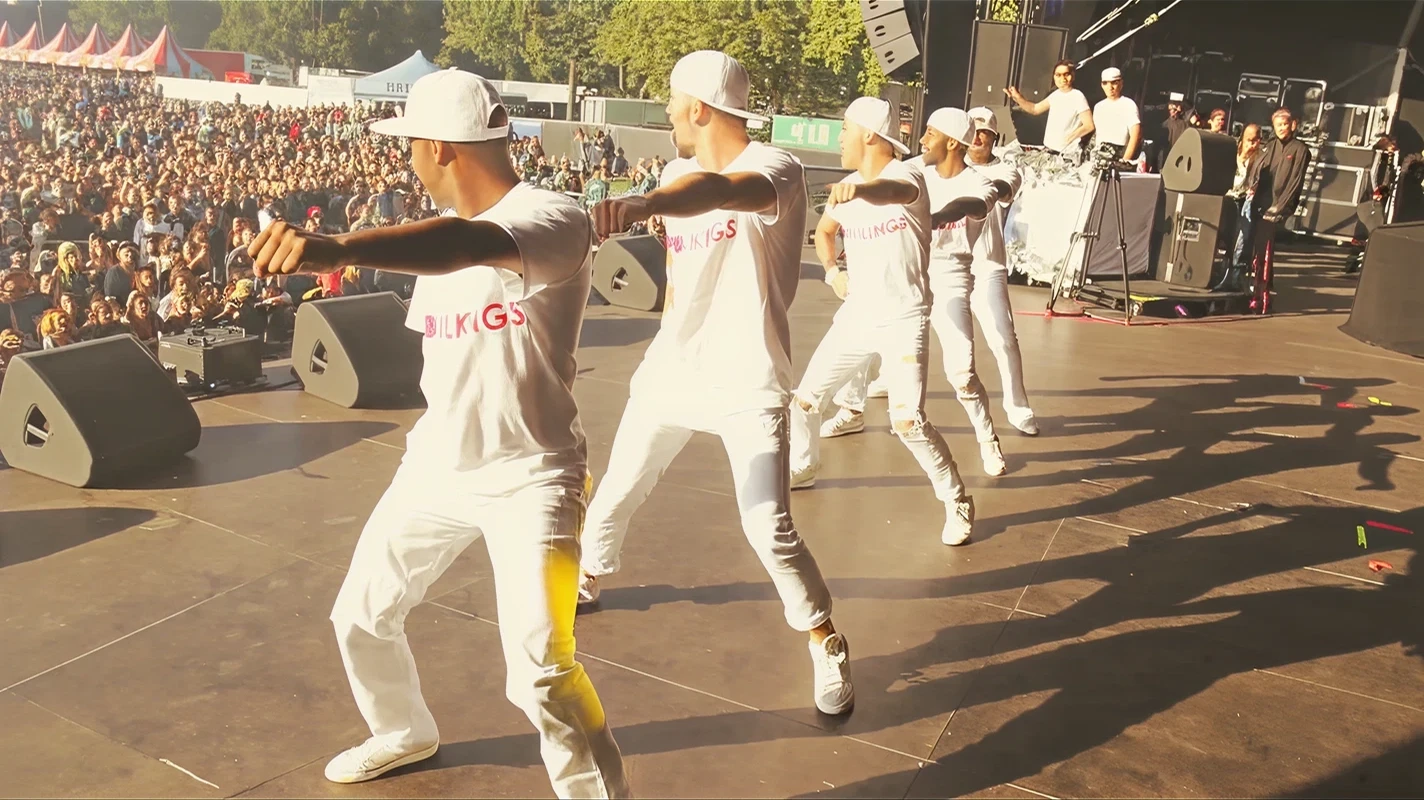 Groove Kings performing on a large outdoor stage in front of a crowd
