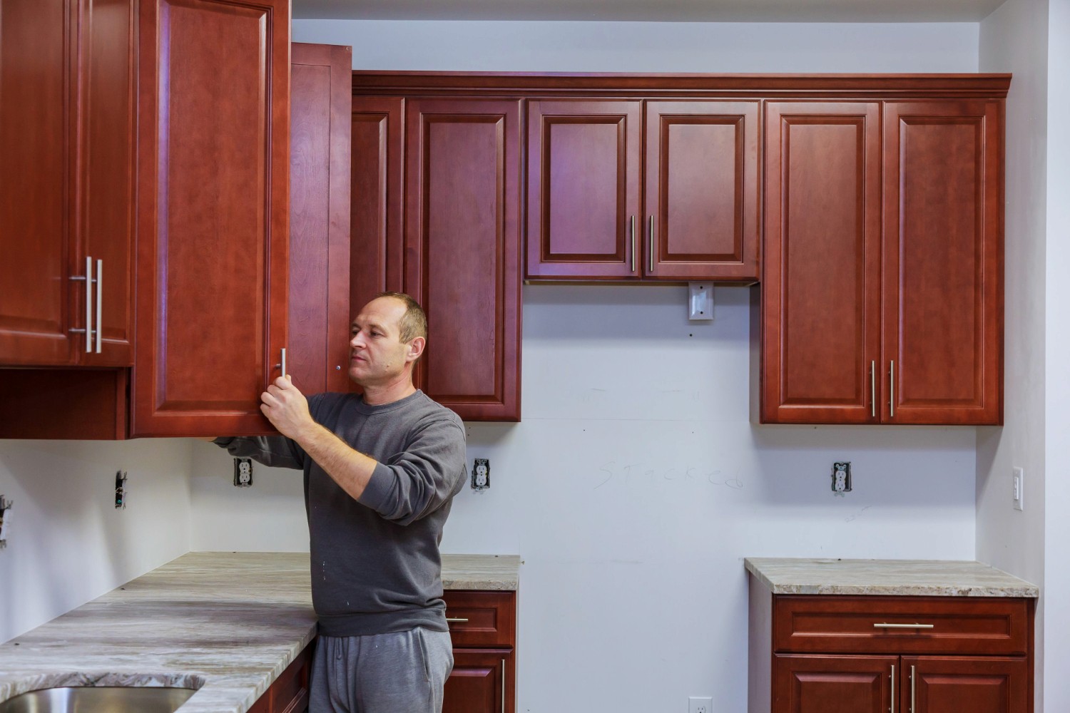 Man inspecting wooden doors for refacing or refinishing