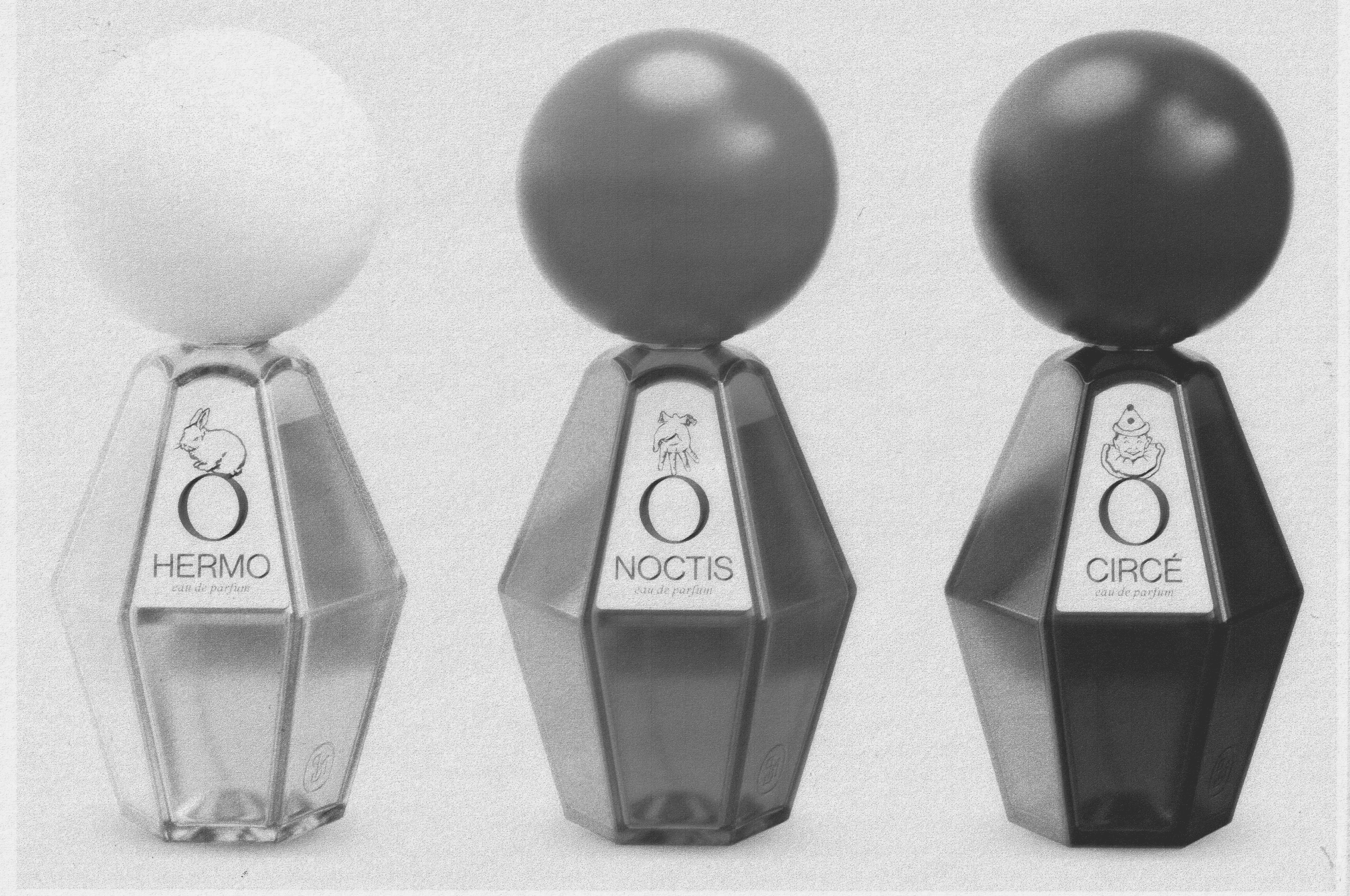 Grainy, black-and-white retro-style photograph showing three FEVVERS perfume bottles side by side: HERMO with a rabbit illustration, NOCTIS with a magician’s hand, and CIRCÉ with a clown figure. The image has a softly nostalgic, vintage quality.