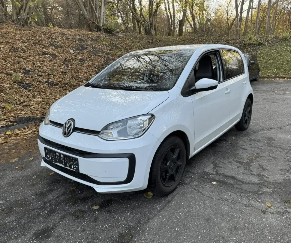 picture of an white volkswagen up that is damaged.