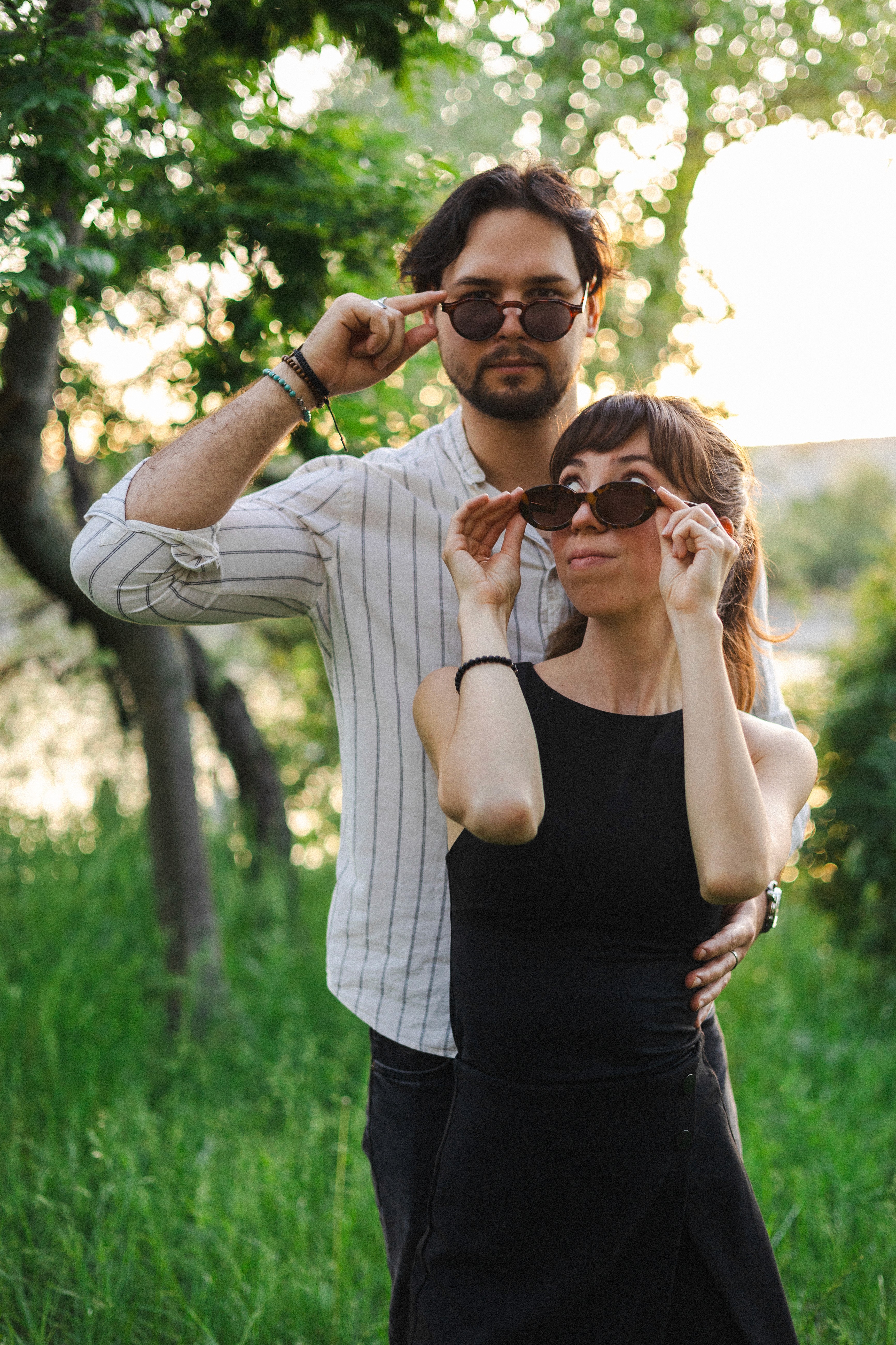Group of people meditating together in a forest clearing with soft morning sunlight streaming through trees.
