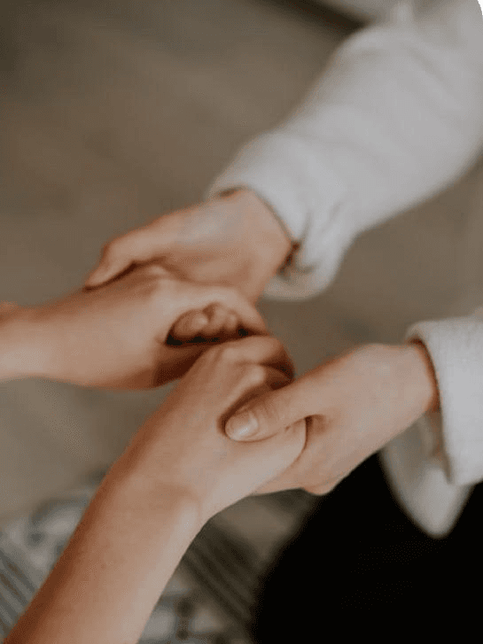 a woman sitting on a couch talking to another woman