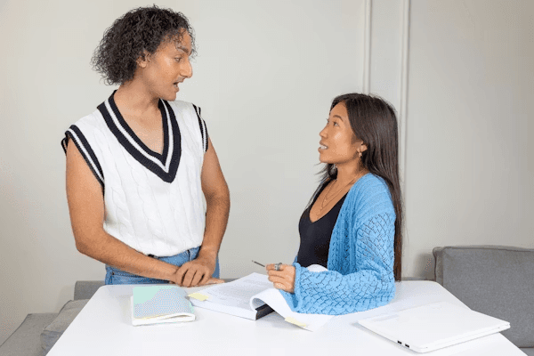 High school student conducting gender studies research with a PhD mentor in an academic setting