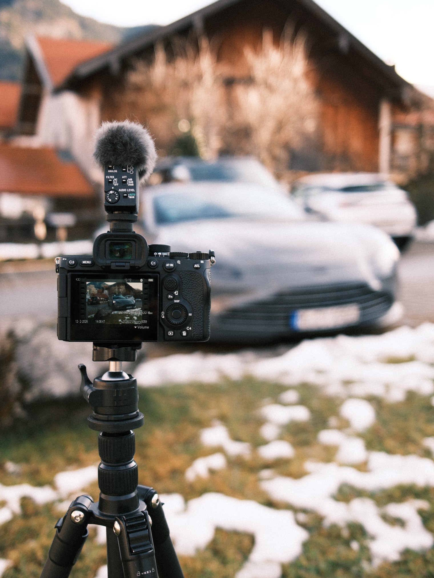 Person with round sunglasses lit by red neon.