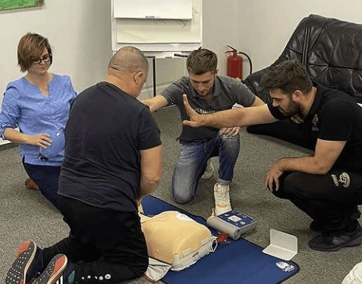 group of people practicing interventions on a doll