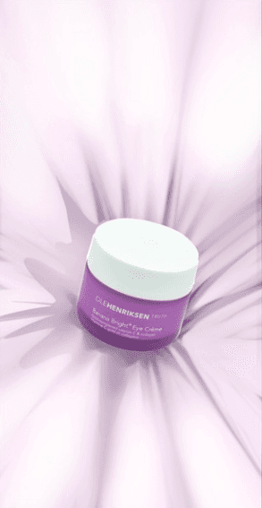 A centered shot of the product jar nestled deep within soft, pleated fabric