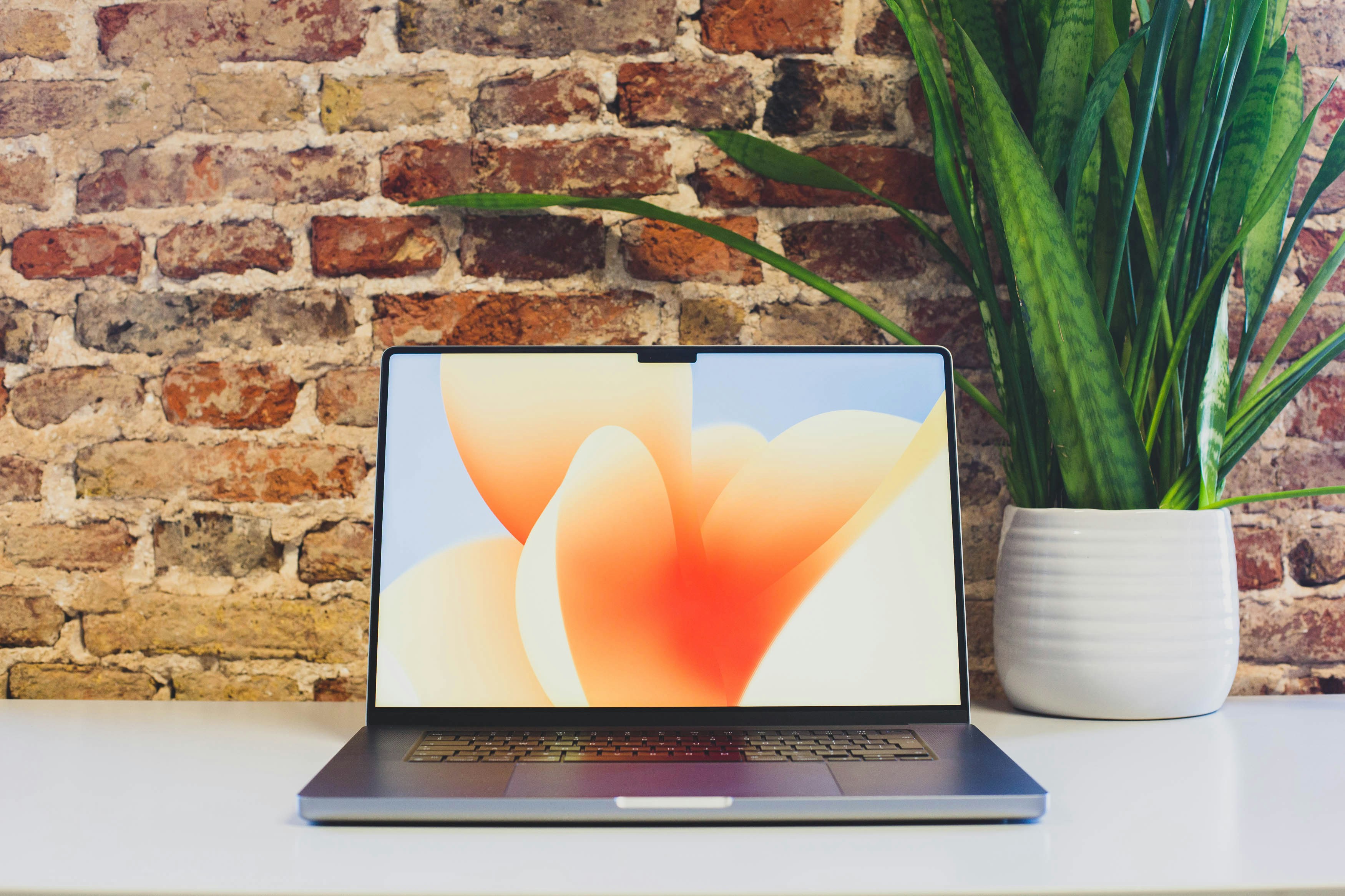 a laptop computer sitting on top of a white desk