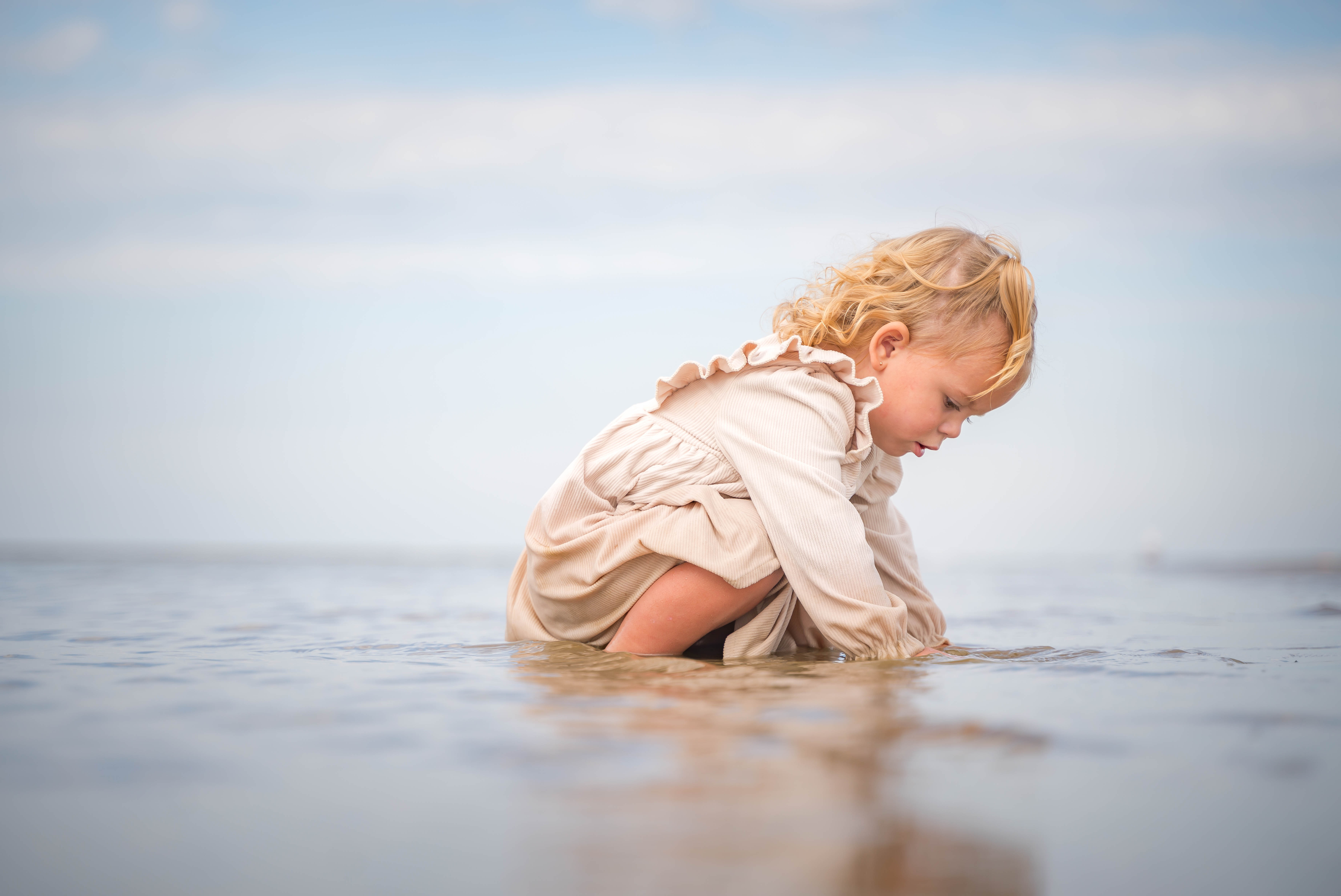 A couple stands outdoors at sunset.