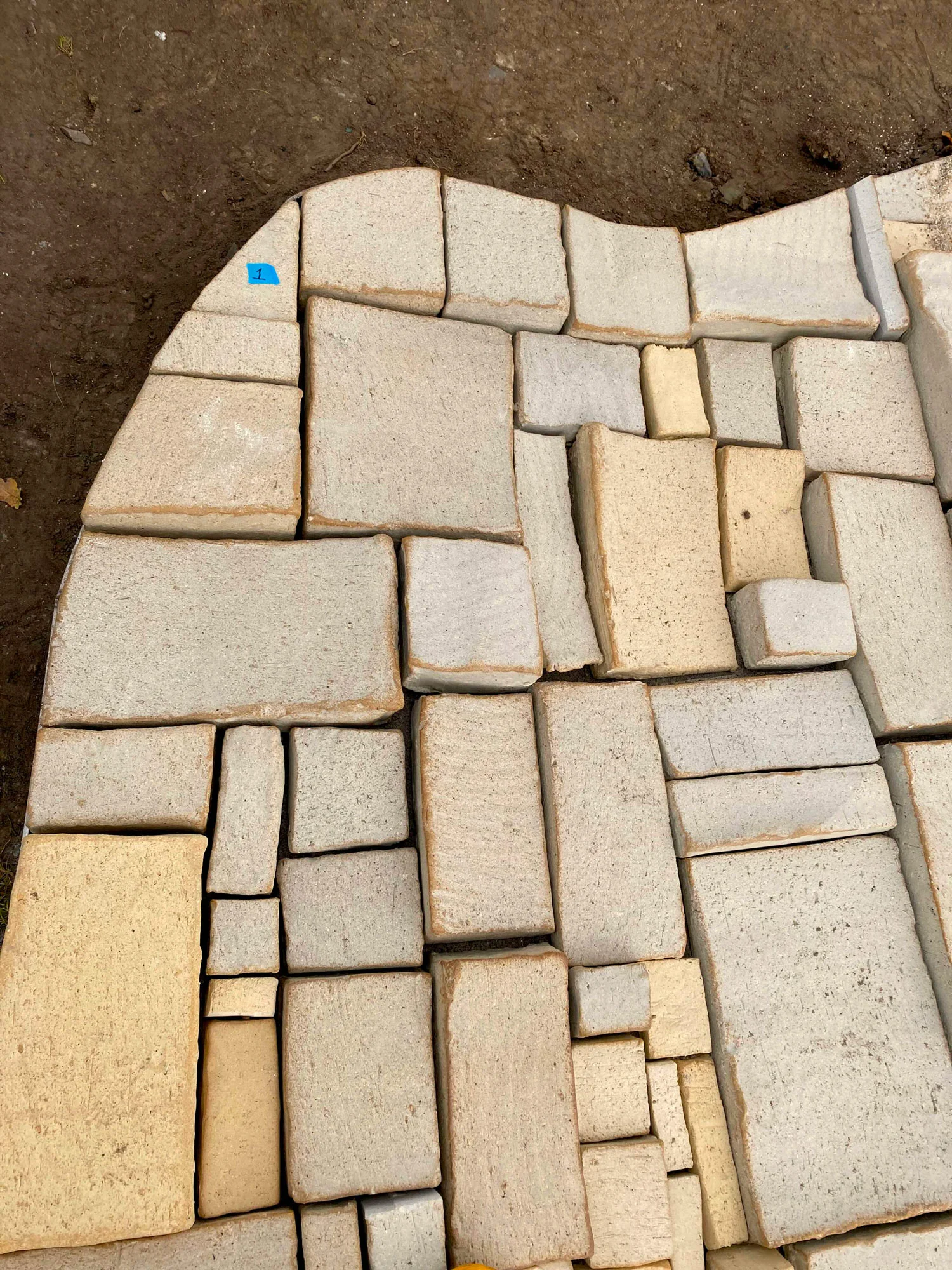 In the making. Laying out the mosaic at Aarhus University, Universitetsparken.