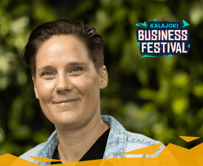 Headshot of Tuulia Virhiä smiling.  In the background is a blurred image of green foliage and the logo for the Kalajoki Business Festival