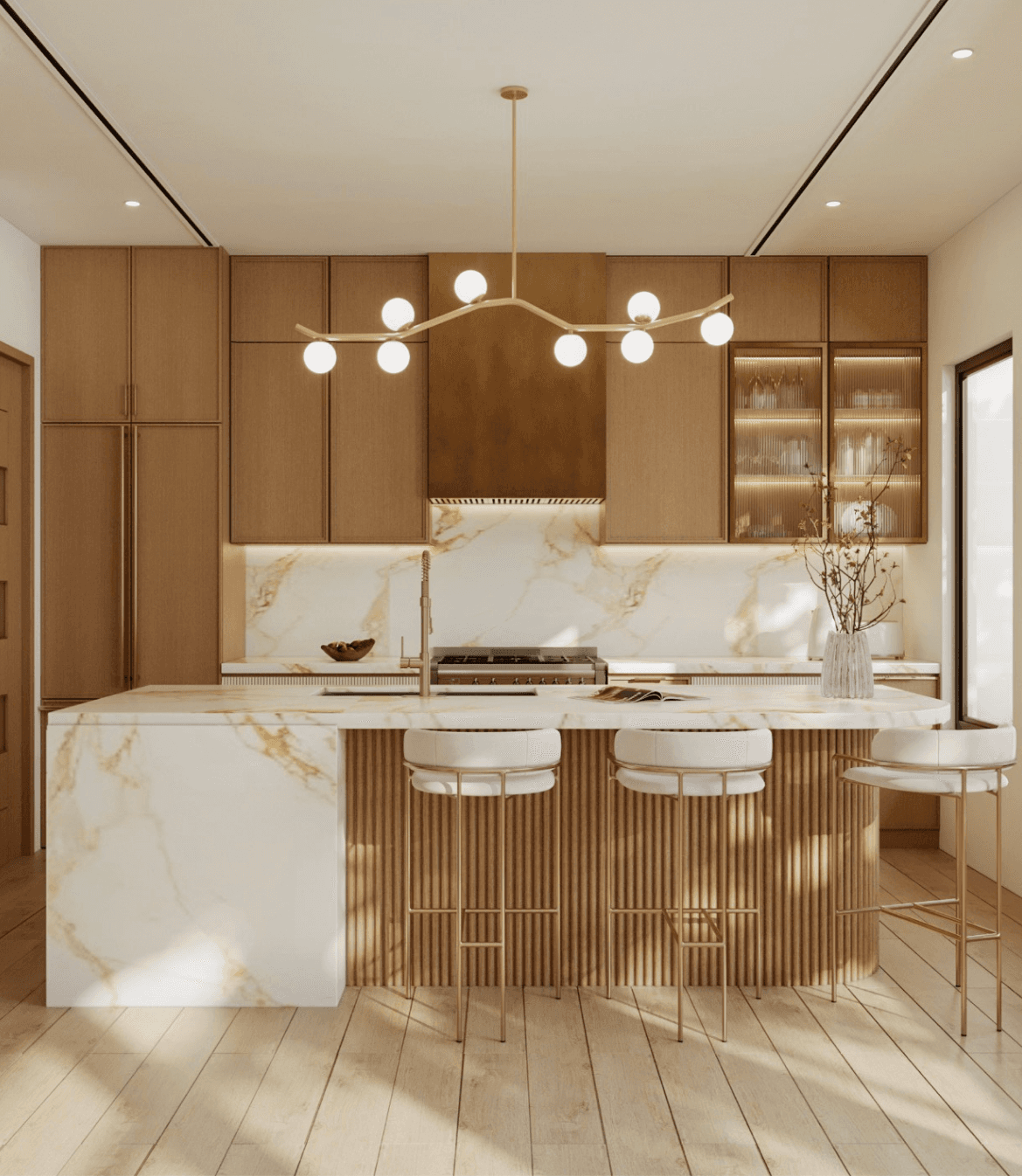 Modern kitchen with marble island, warm wood cabinetry, pendant lighting, and three counter stools.
