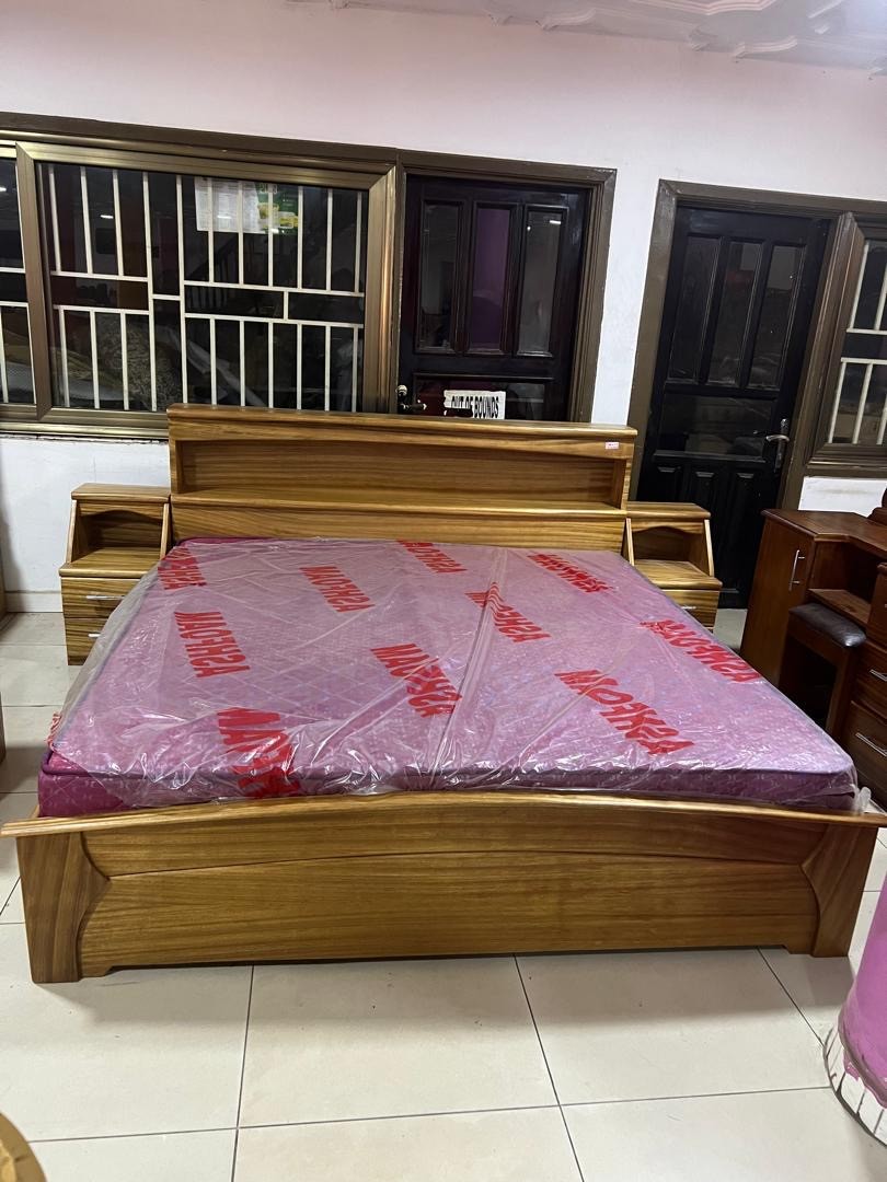 a gray couch with a wooden base on a gray background