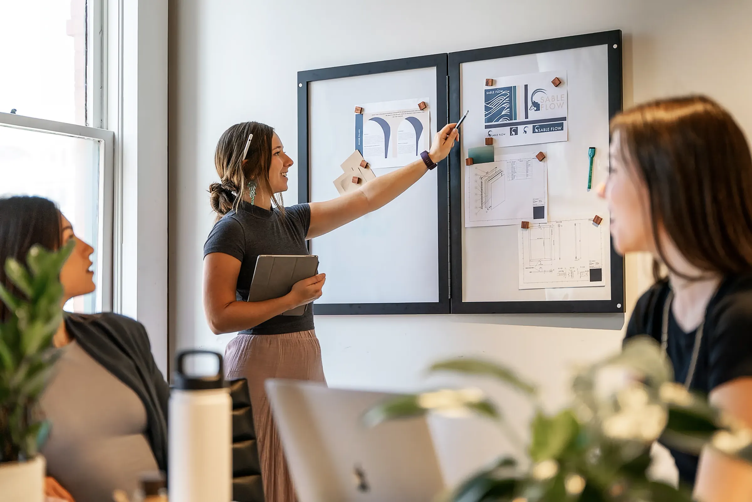 A young girl was explaining her design proposal to two colleagues.