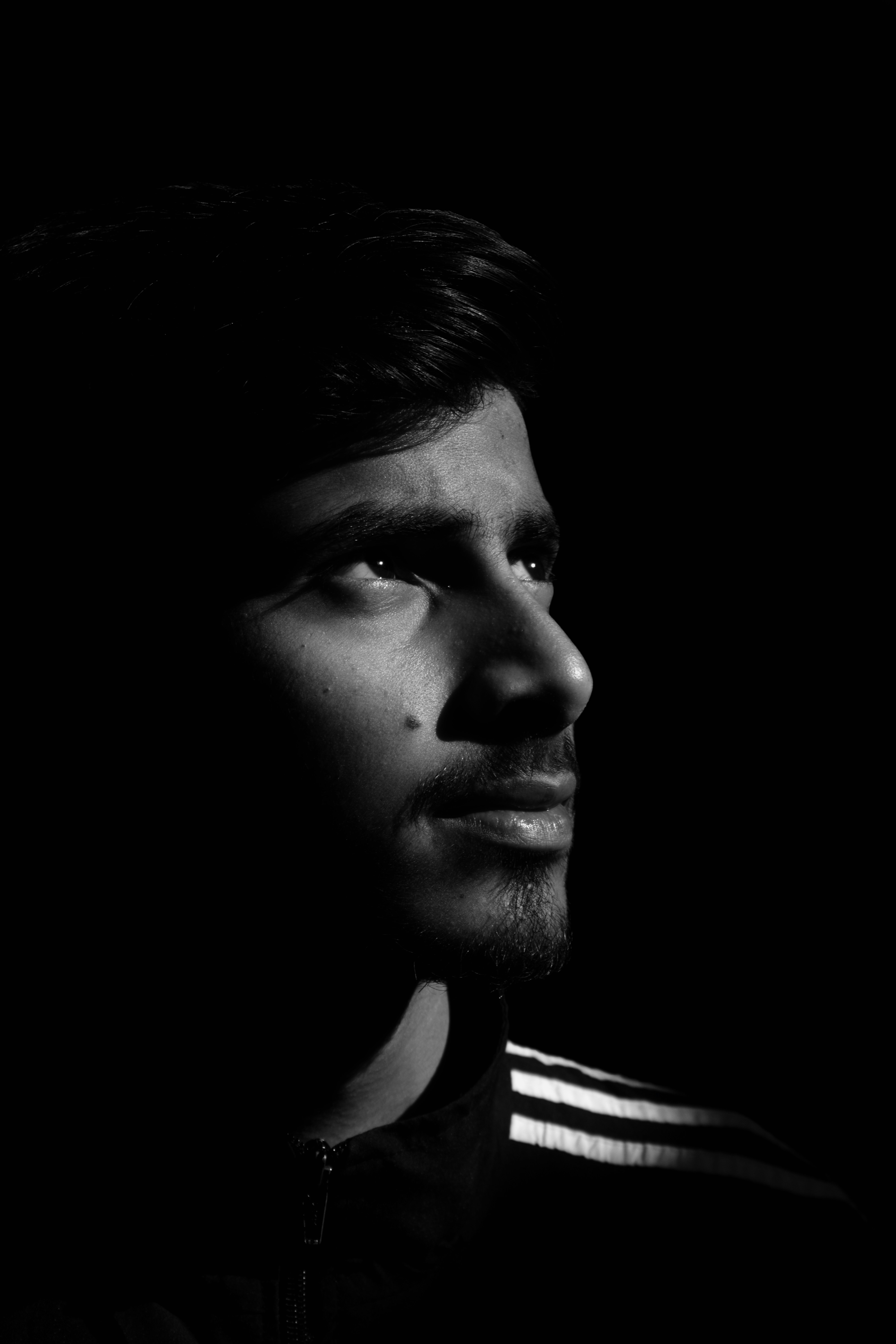 A man in the dark with his eyes closed