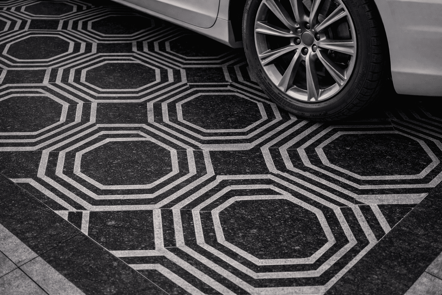 Waves stone paving installed in modern driveway with geometric curved pattern flooring design