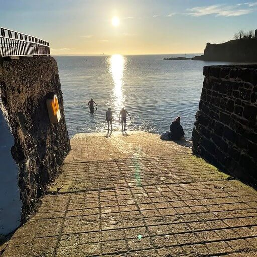 Members swimming on a sunny morning at Lawlors beach