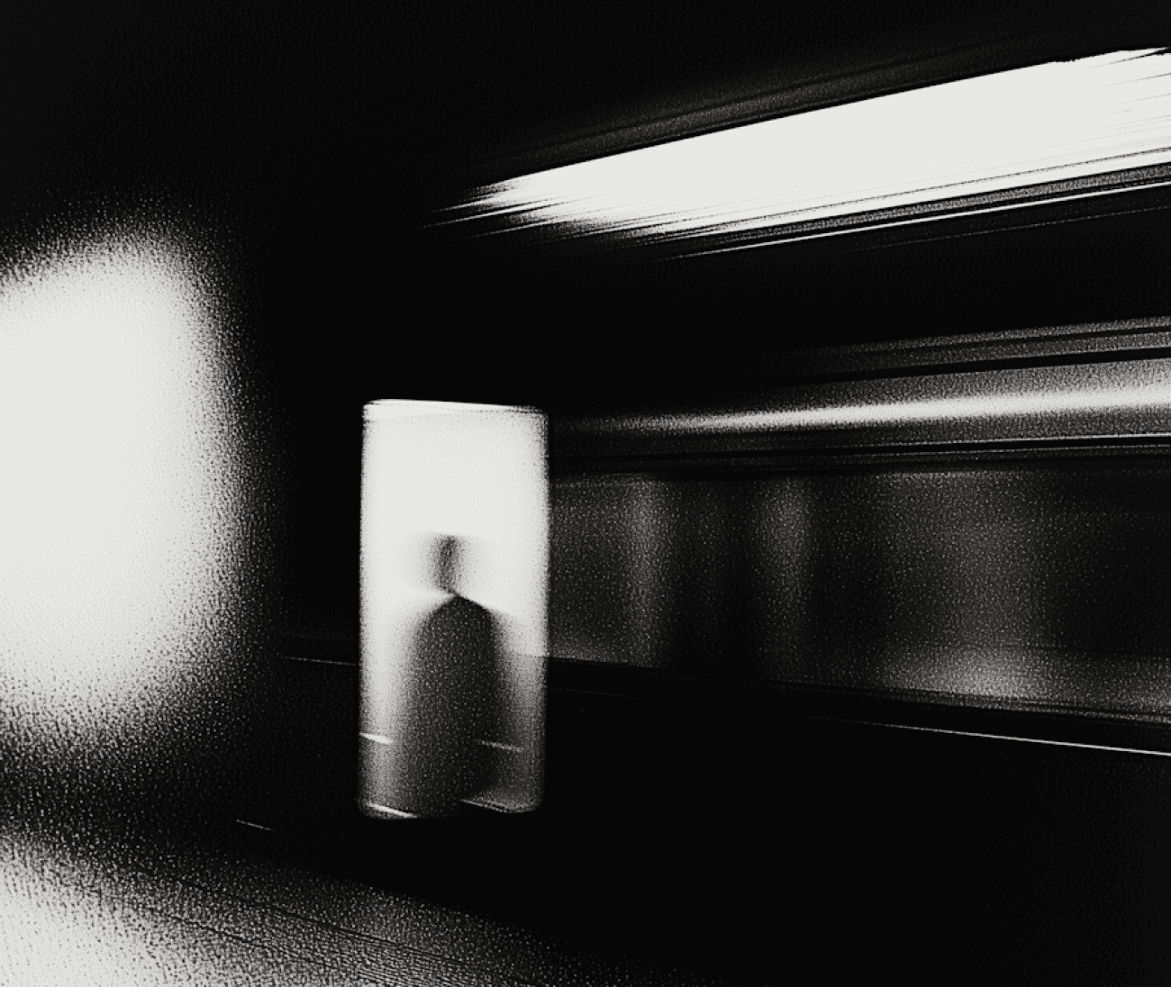 An monochromatic image of a man's reflection captured in a dark melancholic room