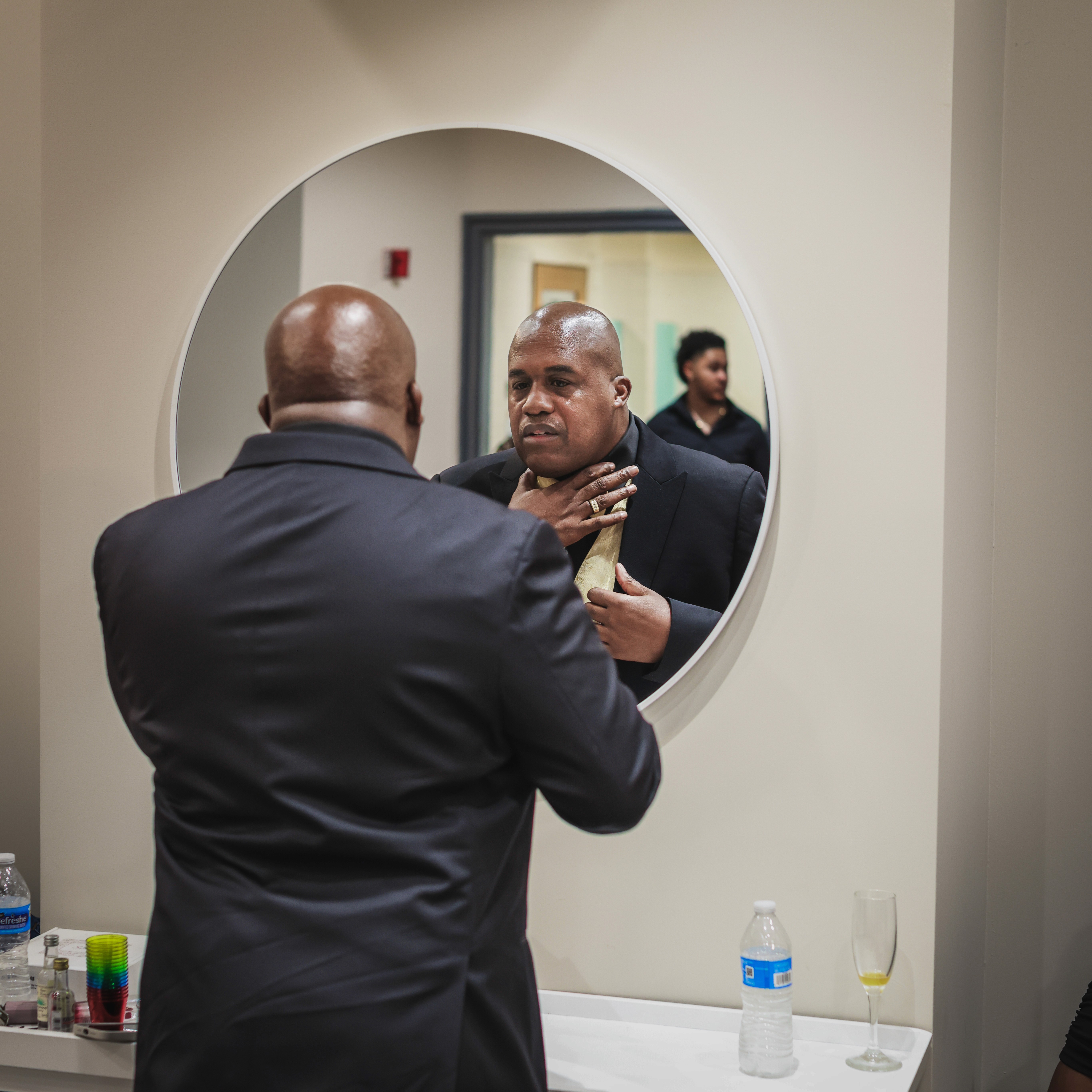 Man getting ready for wedding in mirror reflection