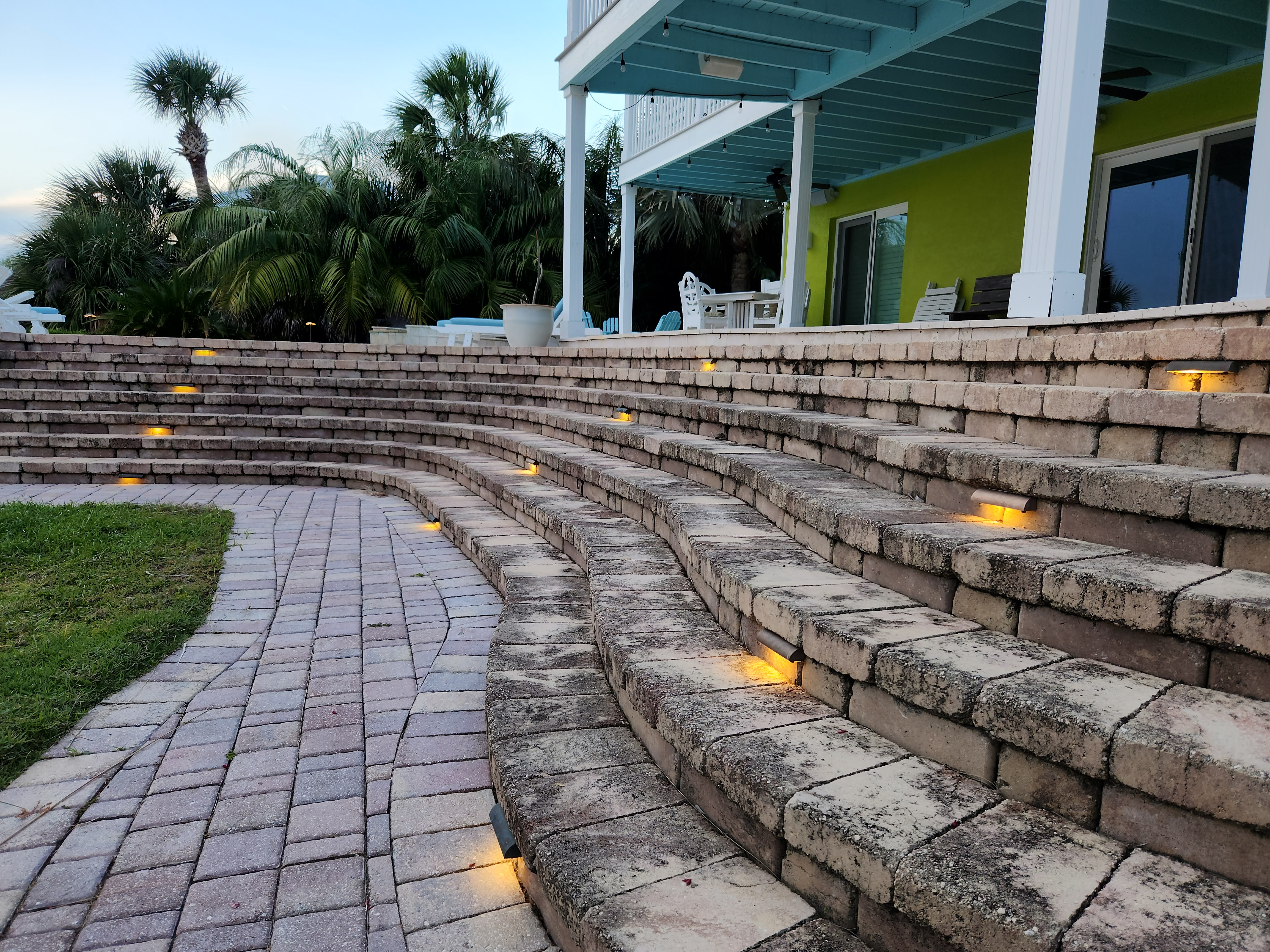 Upgraded outdoor lighting system with renovated fixtures and step illumination