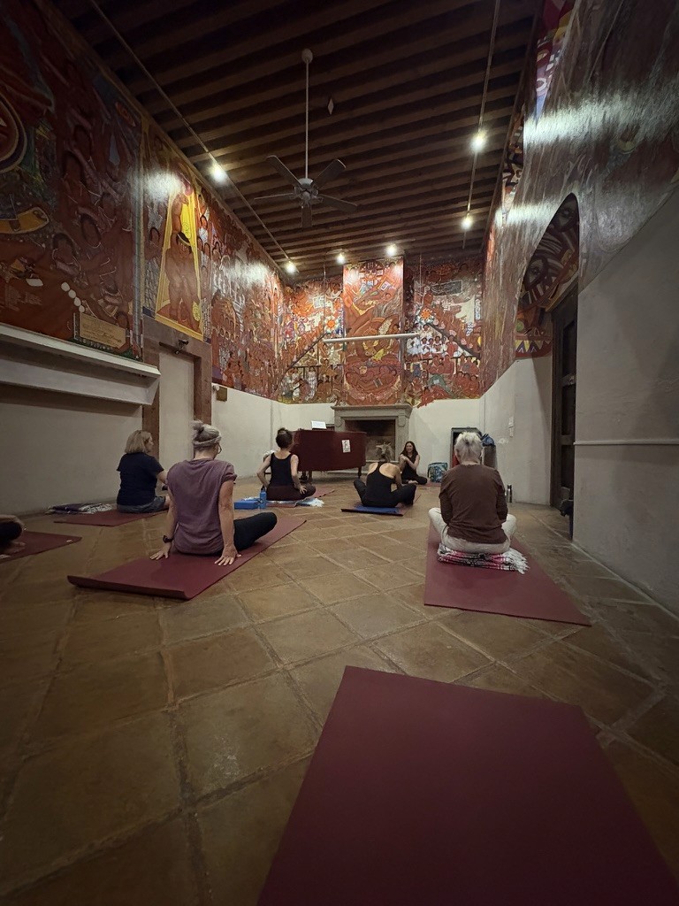 Yoga class in a mural-filled historic room in San Miguel de Allende