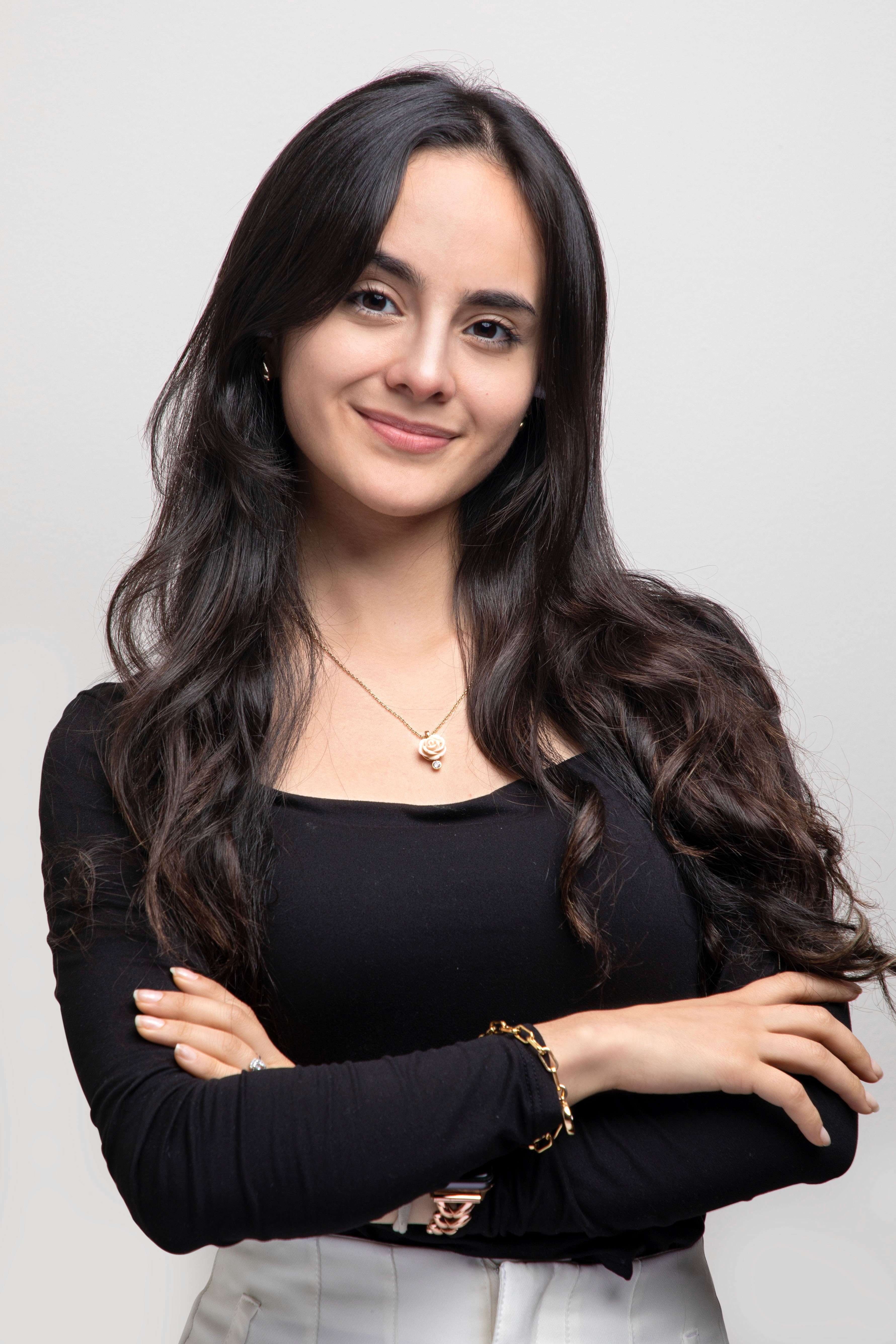 young lady (intern) smiling and folding arms