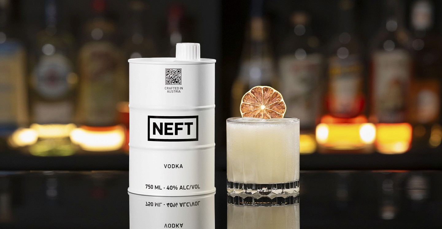 A NEFT Barrel and a glass of Bananarama on a bar counter.