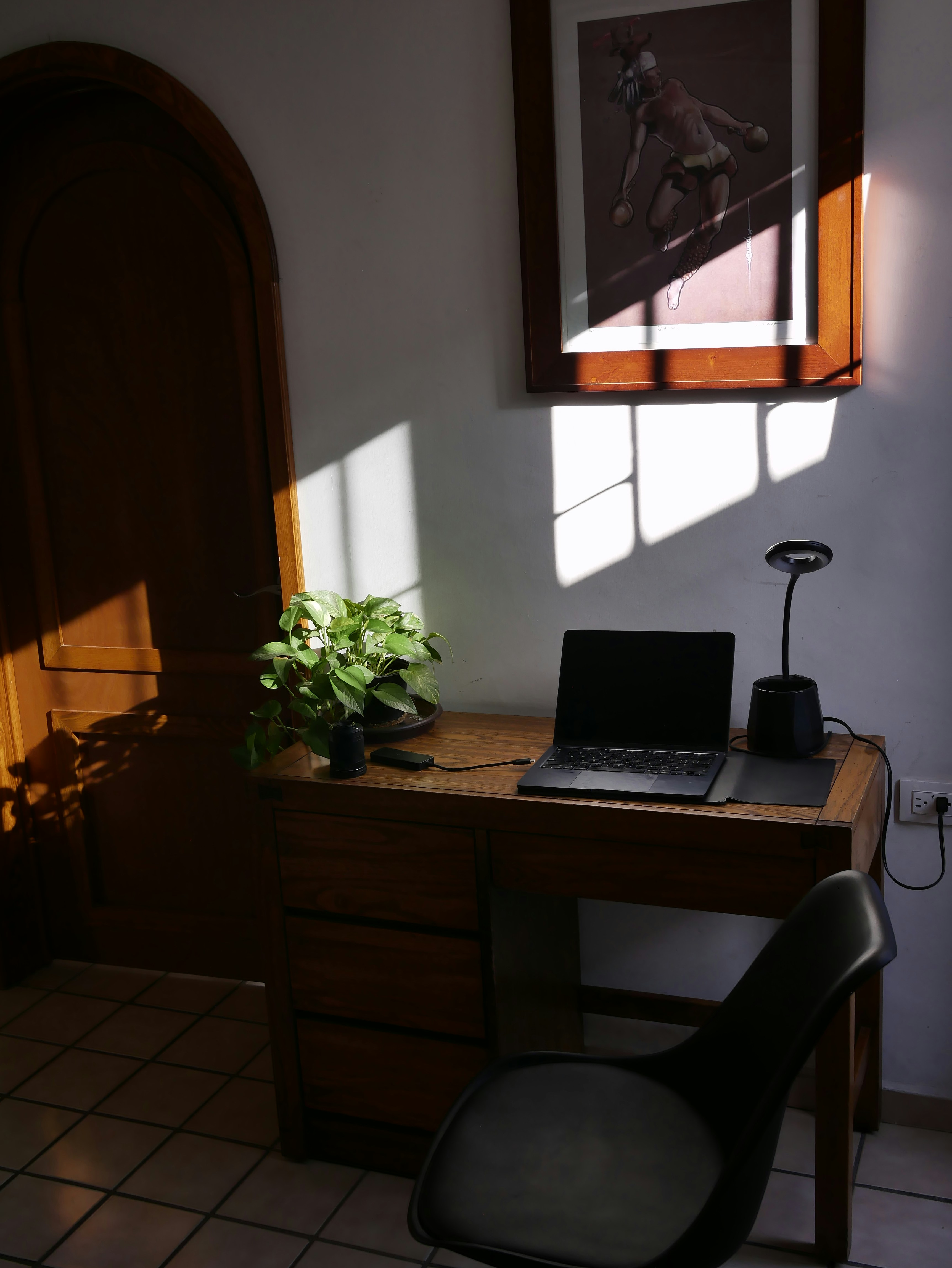 a laptop computer sitting on top of a wooden desk