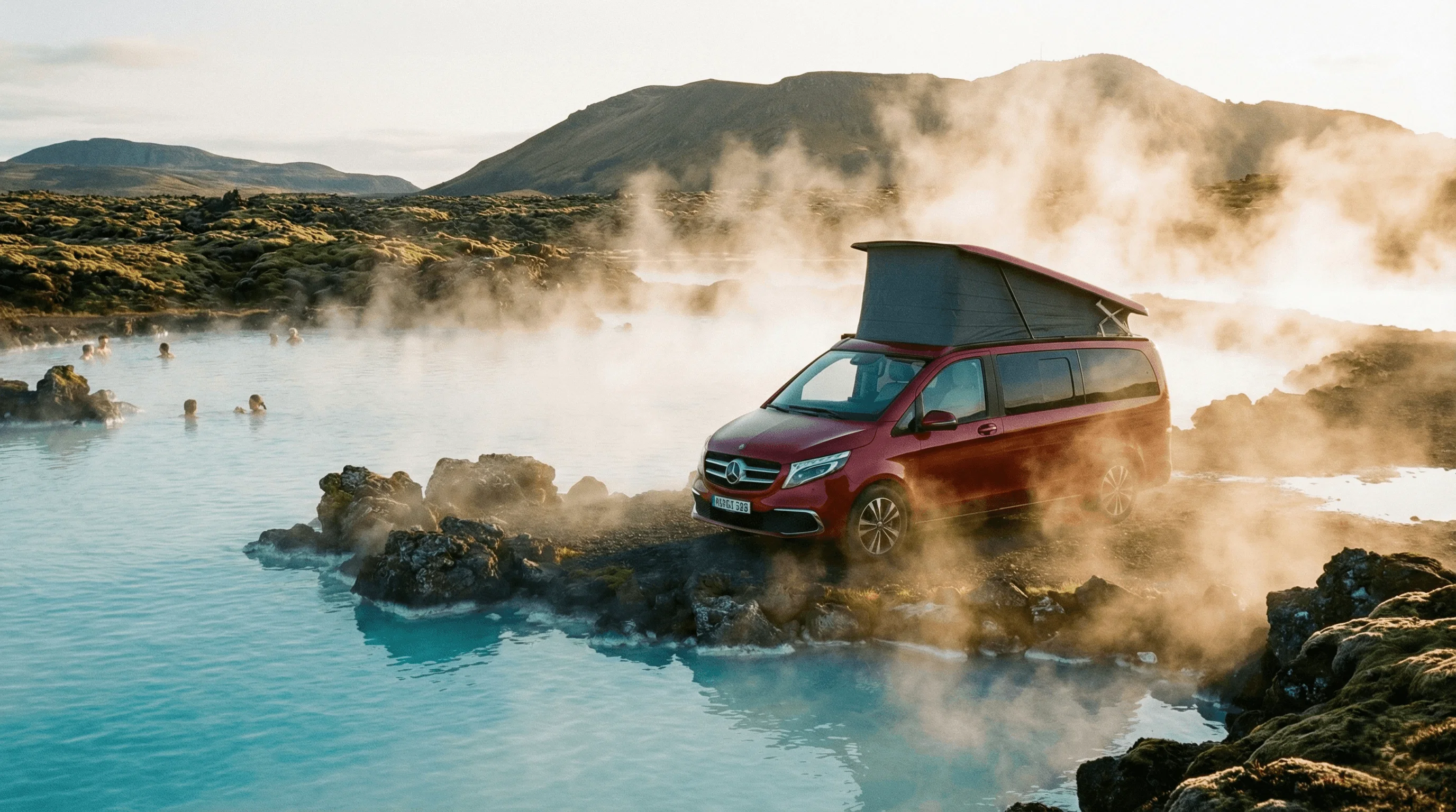 A red camper van with a pop-up roof parked next to a steaming geothermal pool and rocks.
