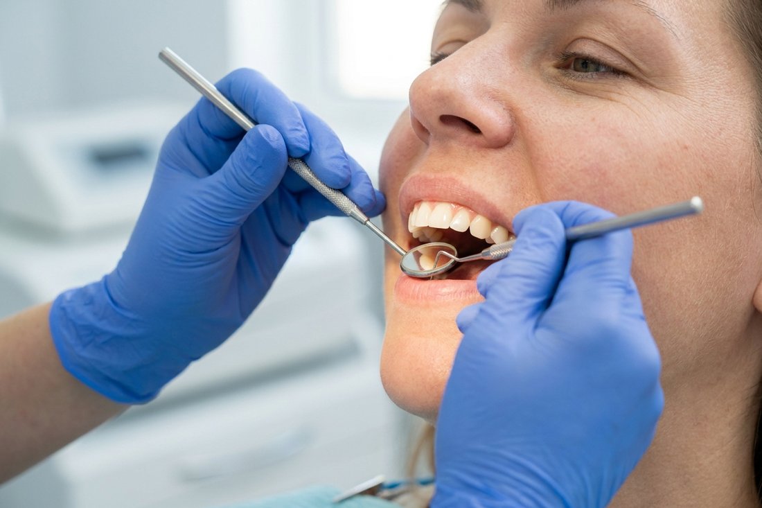 Dentist examining a patient's gums with a mirror during a checkup