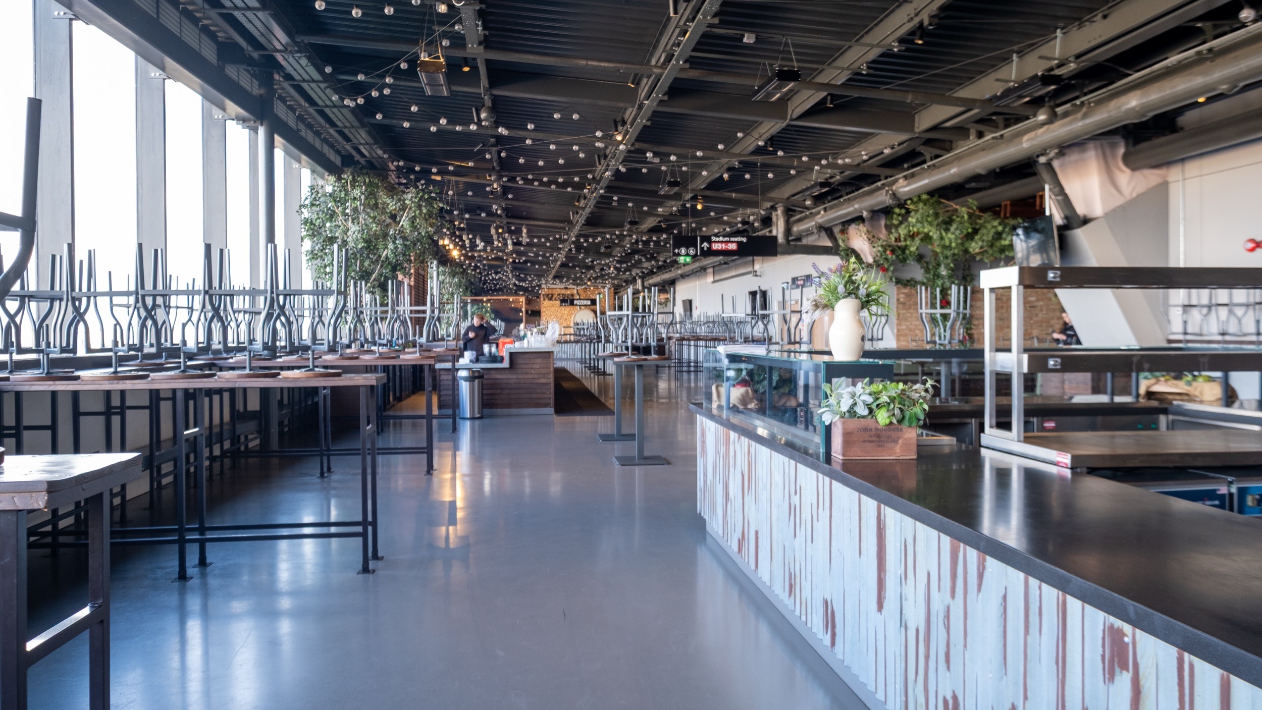 Two classic volkswagen beetles, one green, one cream.