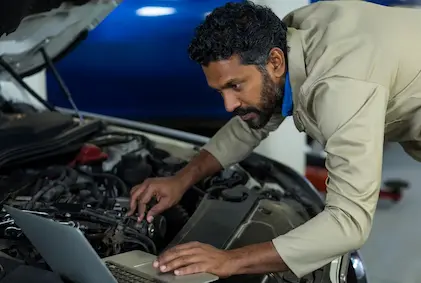 Mechanic running diagnositc checkup on EV