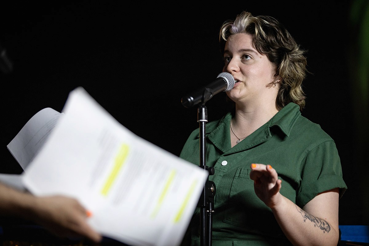 A performer speaks into a microphone.