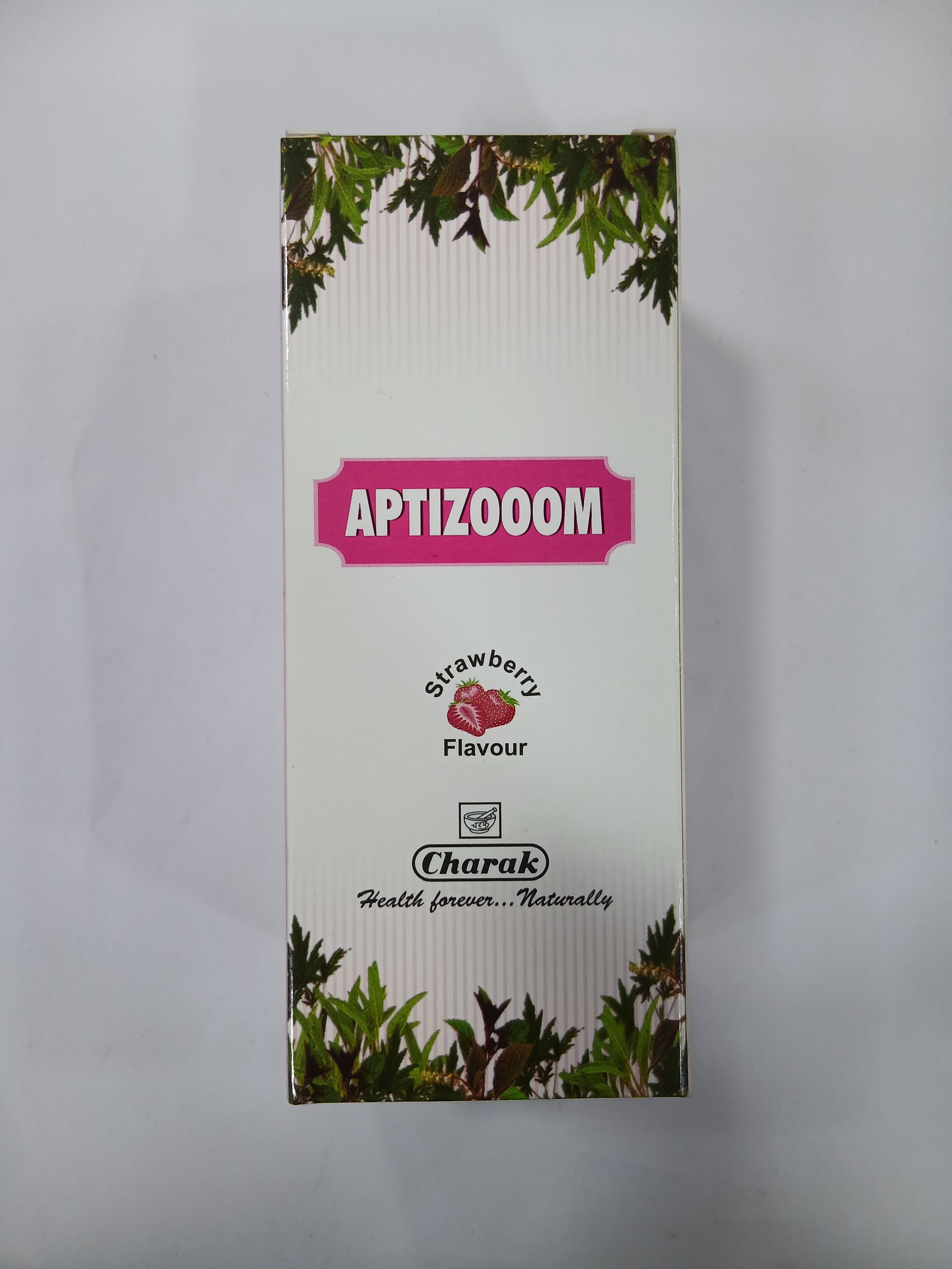 White cardboard packaging with green leafy borders features a pink label displaying the word "APTIZOOM" and text indicating "strawberry flavour" alongside a small red strawberry graphic.
