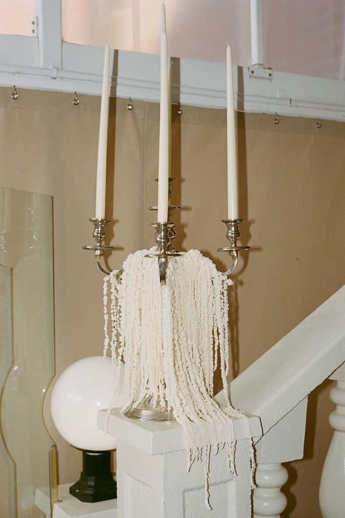Statement candelabra with cascading bleached flowers used as sculptural wedding décor