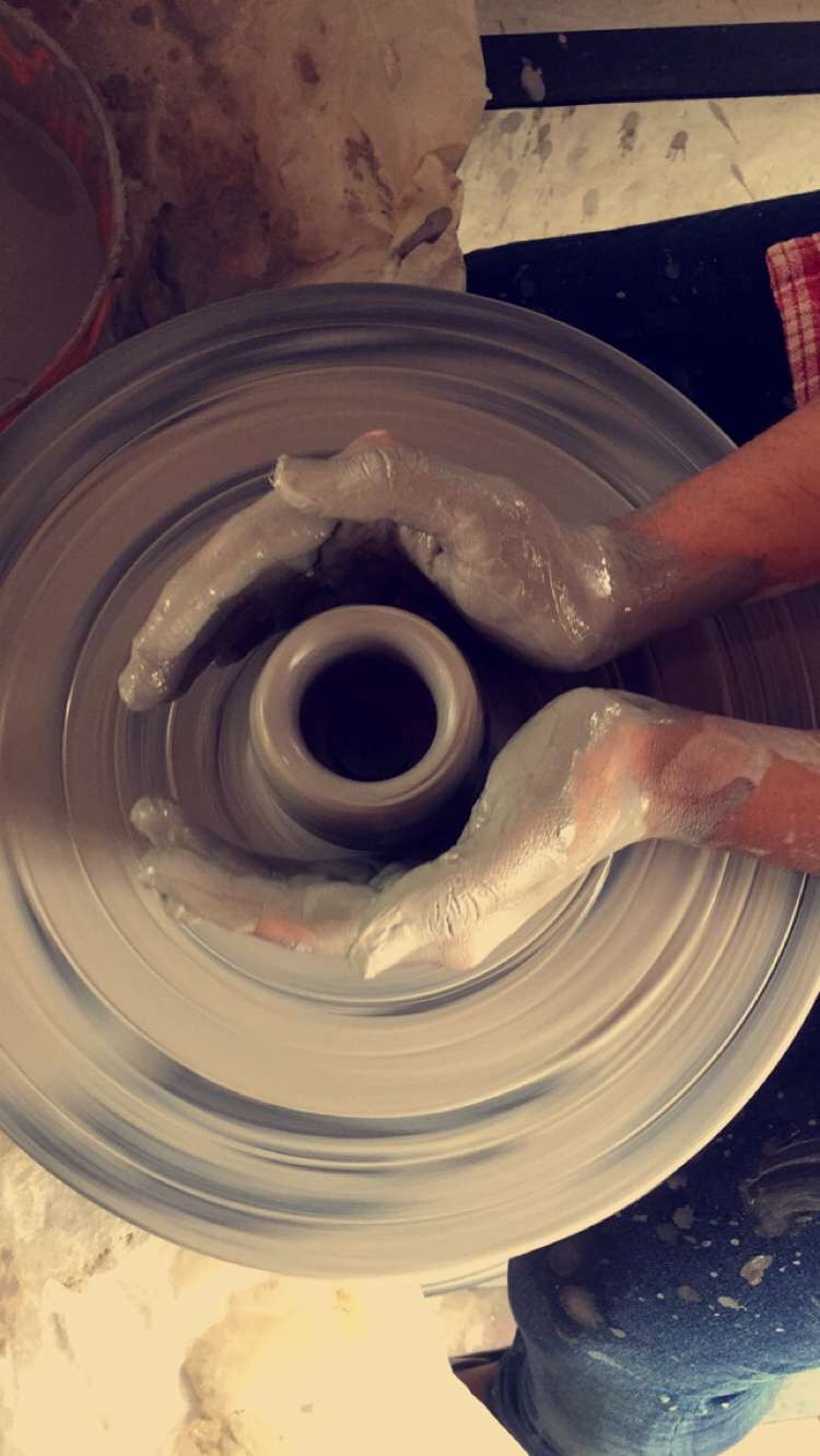 Two people talking on a rooftop at sunset