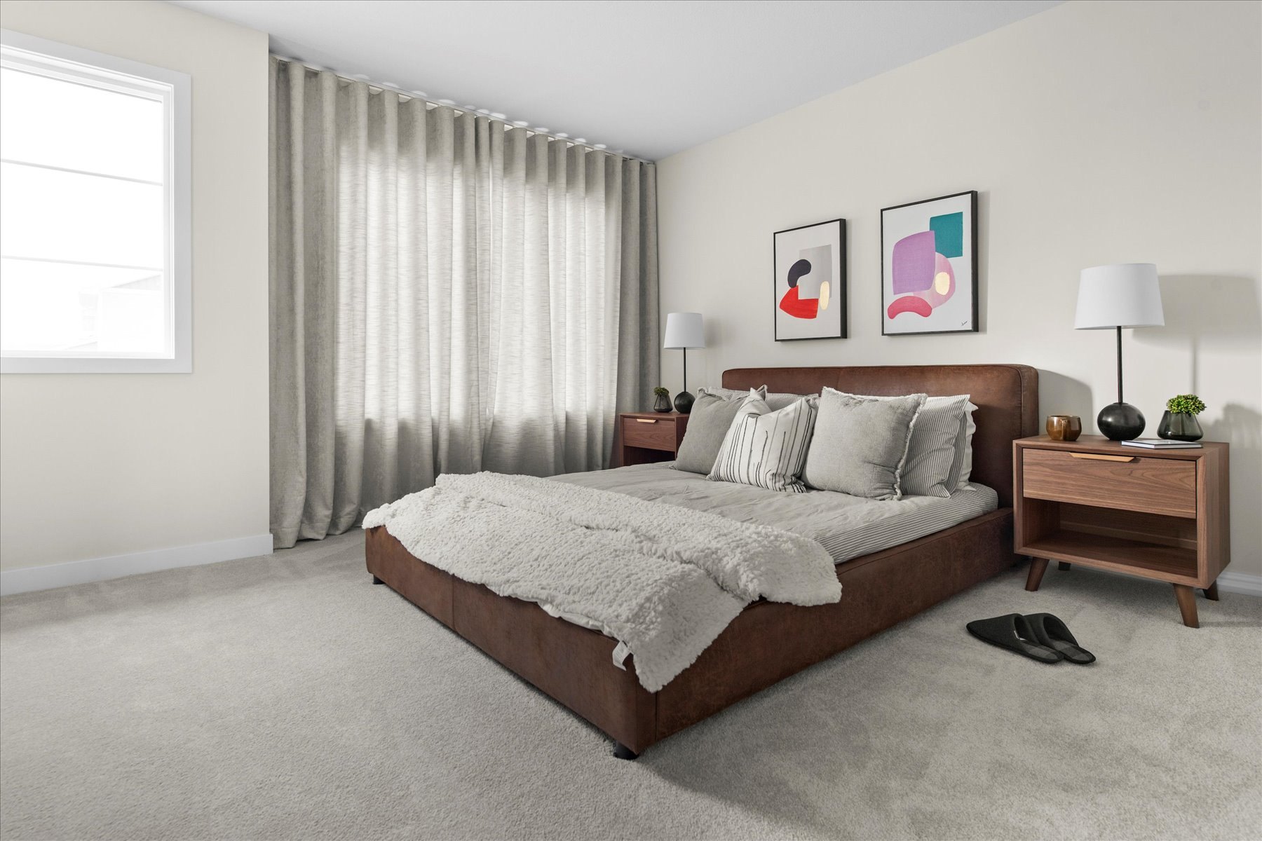Heartland primary bedroom styled with a leather bed, linen drapery and walnut nightstands