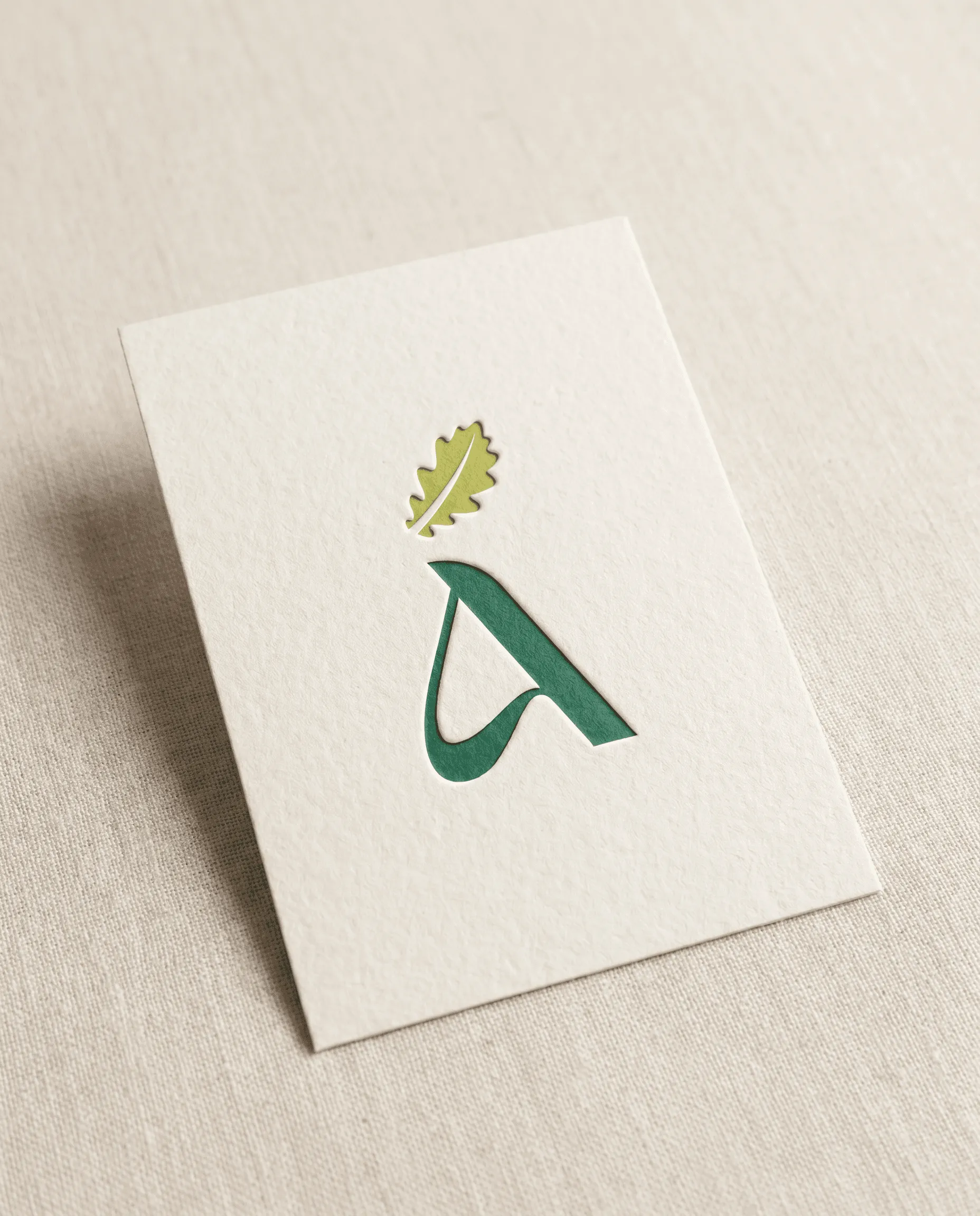 Aleza letterpress business card with debossed oak leaf logo detail