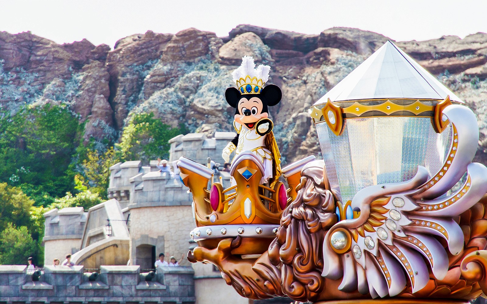 Tokyo Disneyland castle with visitors enjoying the theme park atmosphere.