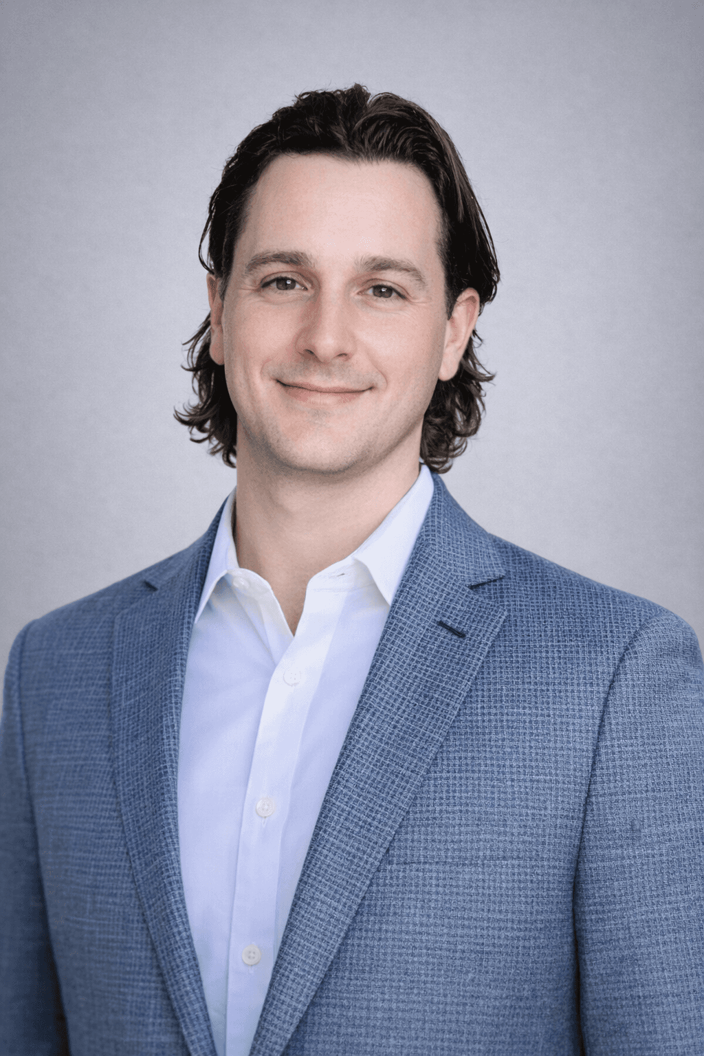 Black and white portrait of a smiling person with curly hair