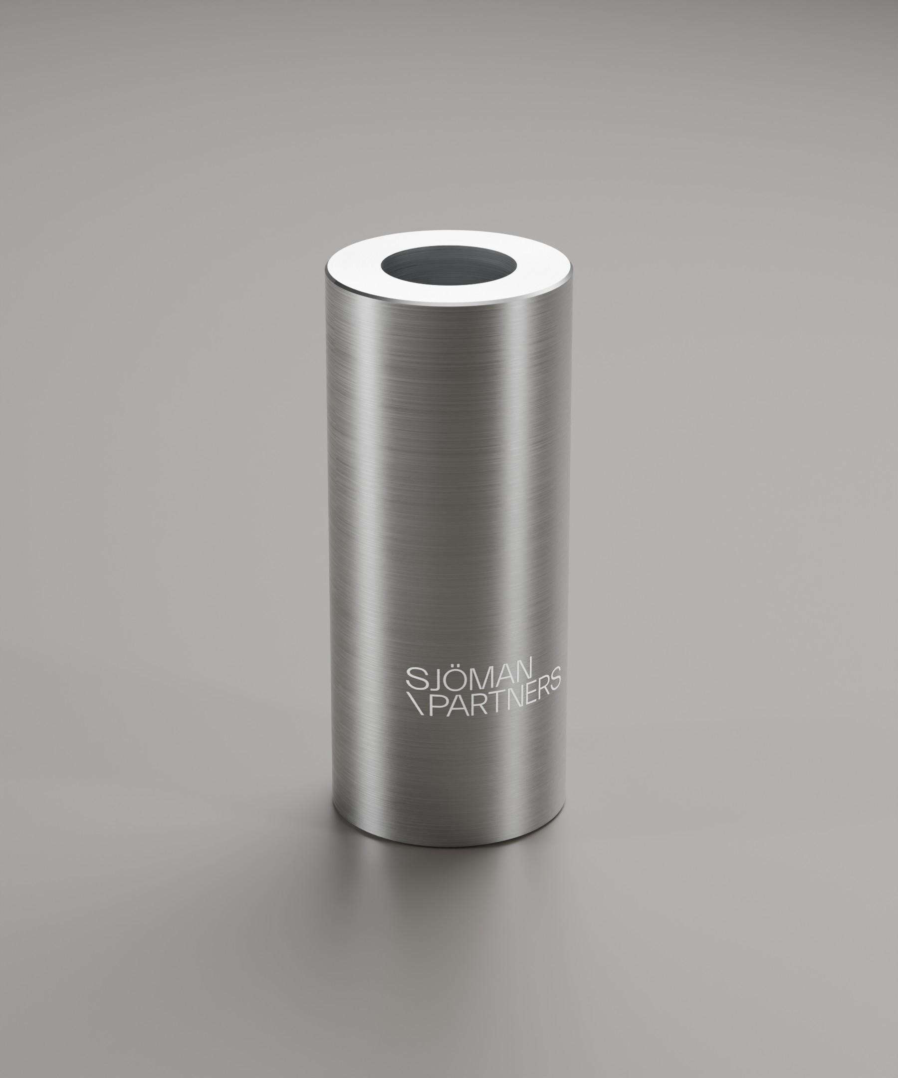 Tall cylindrical metal candleholder with understated Sjöman Partners branding