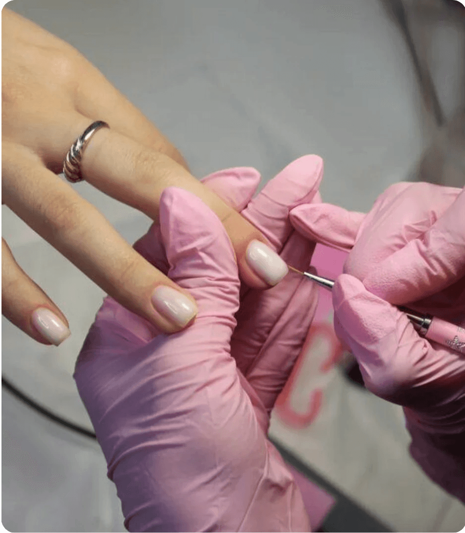 Man places ring on woman's finger with blue background