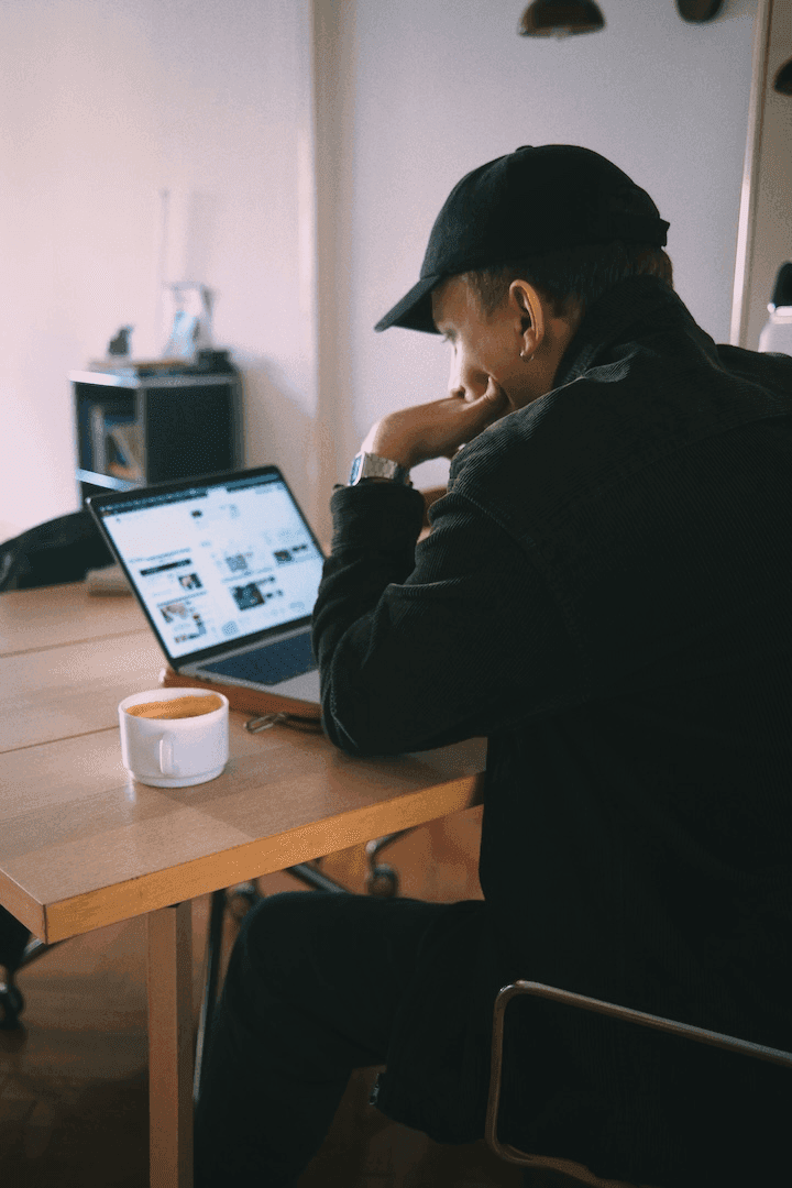 a desk with a laptop on it in front of a window