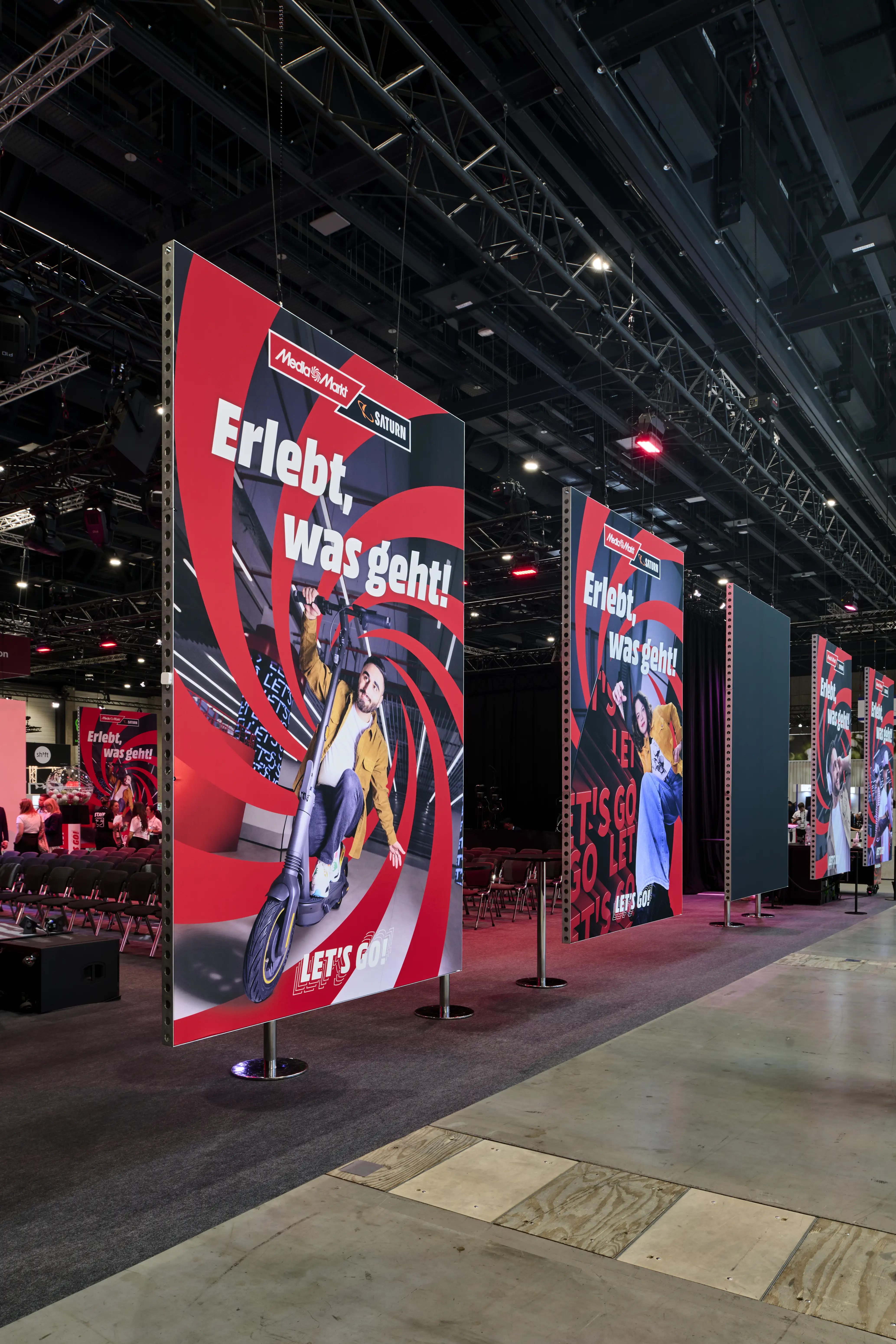 Hanging MediaMarkt banner panels reading Erlebt, was geht in the IFA exhibition hall.