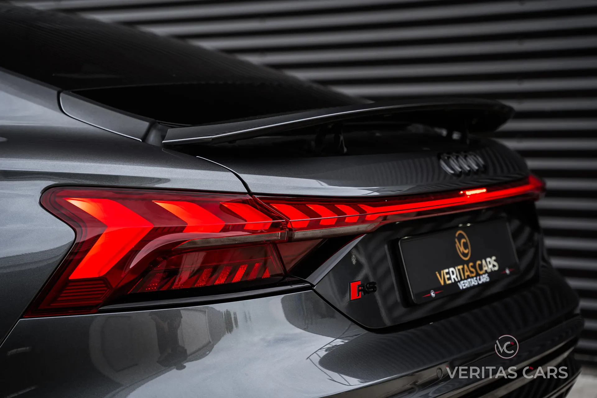 Backside image of an Audi in front of a garage door