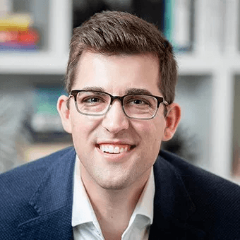 man wearing green crew-neck top and eyeglasses with black frames looking at side