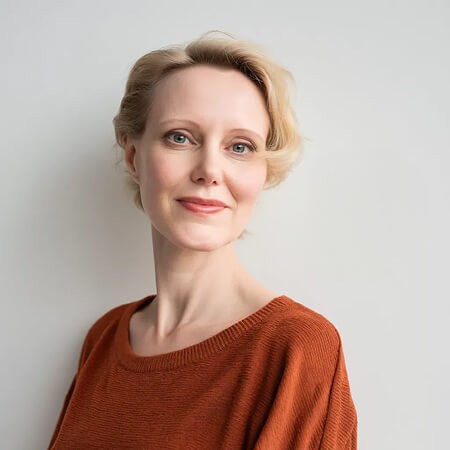 Portrait of a calm woman in a terracotta top representing the Emotional Support & Midlife Identity prompt pack for menopause coaches