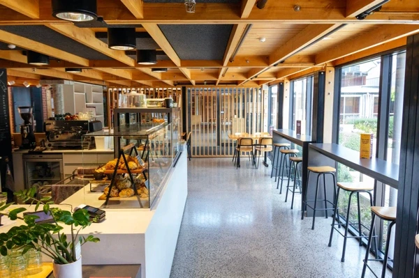 Interior of the Cloister Café with display cabinet and window seating