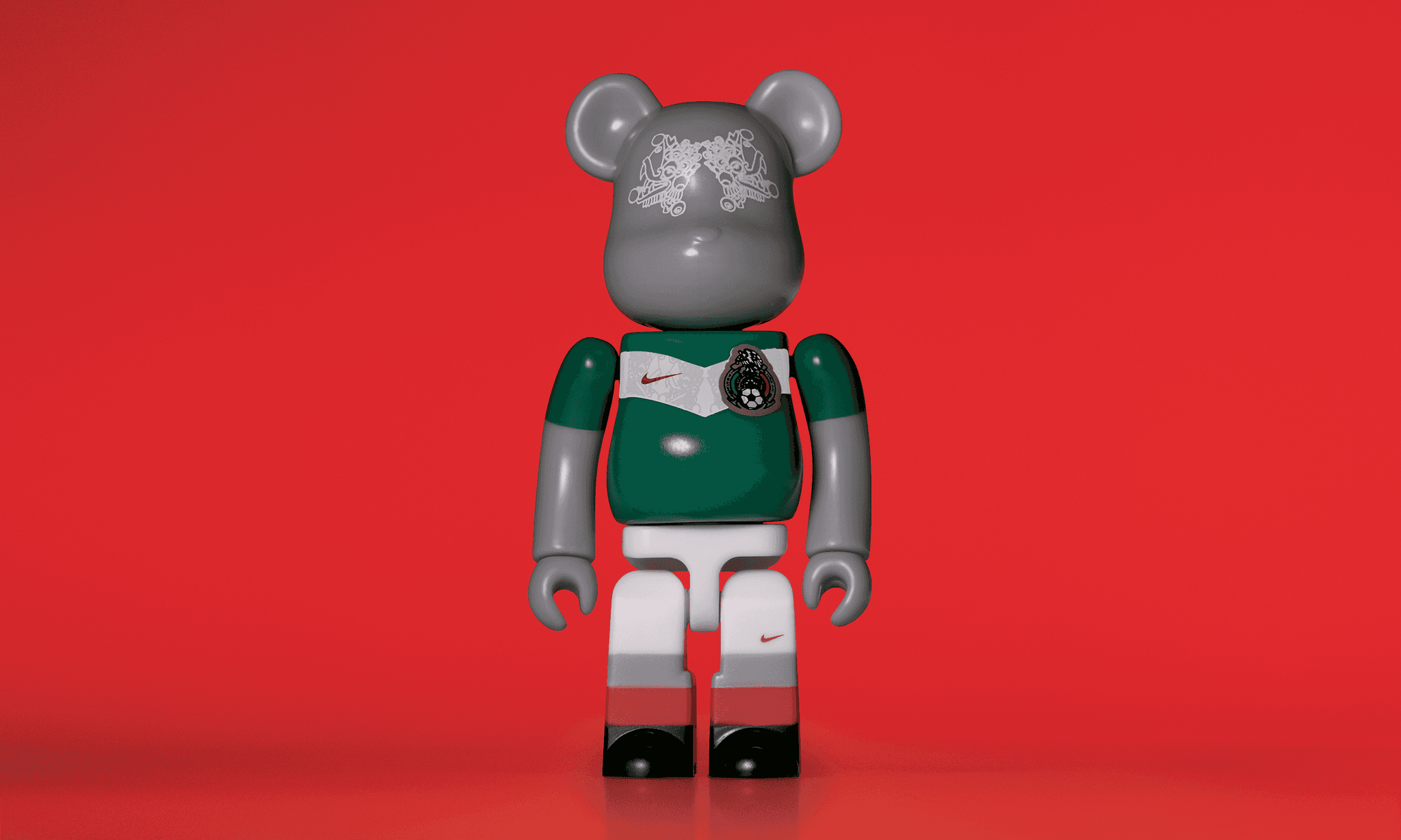 A single 3.5” tall Bre@rbrick/Nike toy created to commemorate the 2006 Mexican World Cup football team. The toy is painted to appear in the Mexican football kit and stands in the center of the frame in front of a red background.